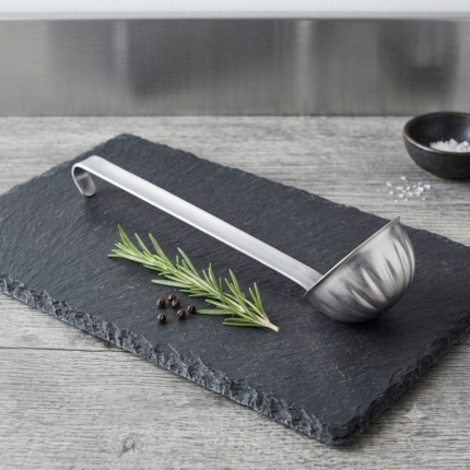 Stainless steel soup ladle with a long handle for serving and scooping in the kitchen.