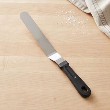 Stainless steel spatula with a black handle for leveling and decorating cakes and desserts
