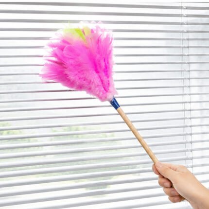 Natural feather duster with a wooden handle for highly effective cleaning of furniture and appliances.