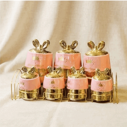 7-piece ceramic spice set on a stylish pink and gold metal stand