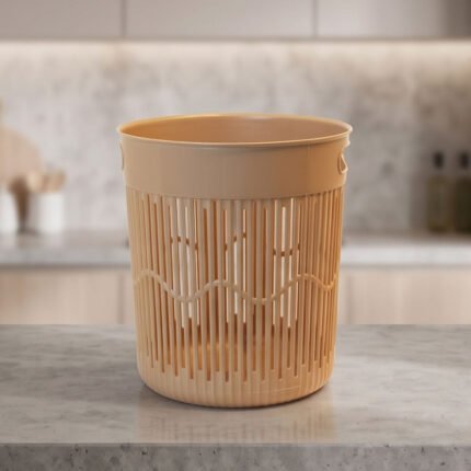 Round, empty plastic wastebasket for office and rooms, beige color